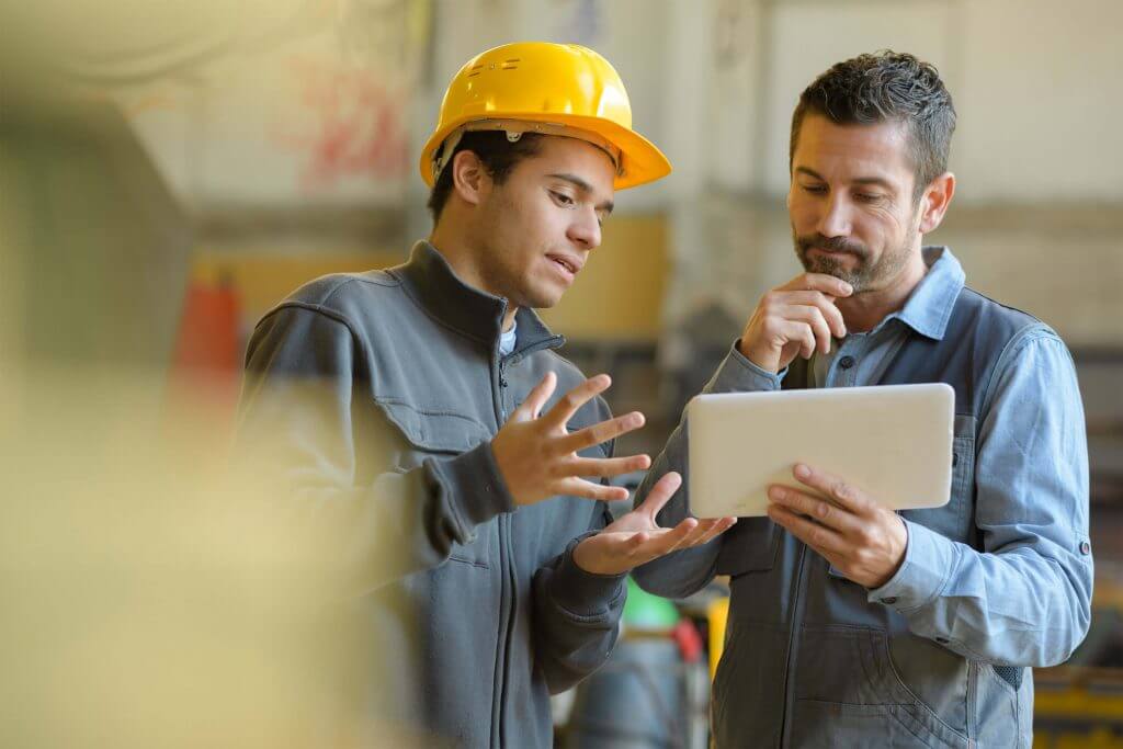 2 men in work looking at tablet screen