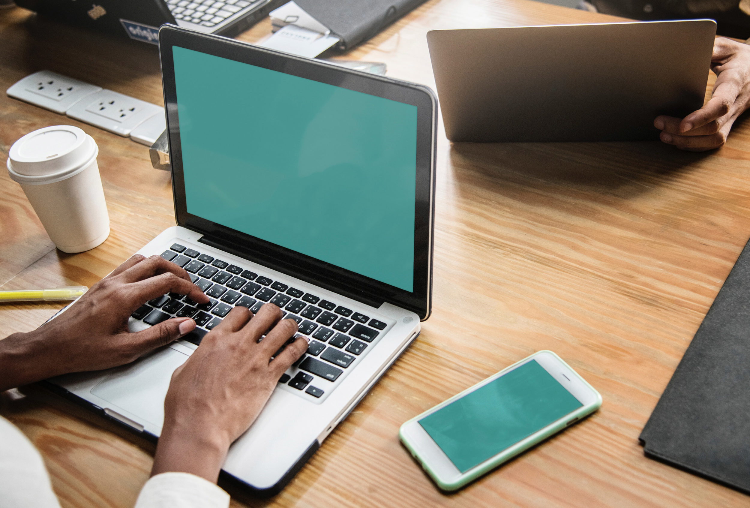 Person using laptop and phone