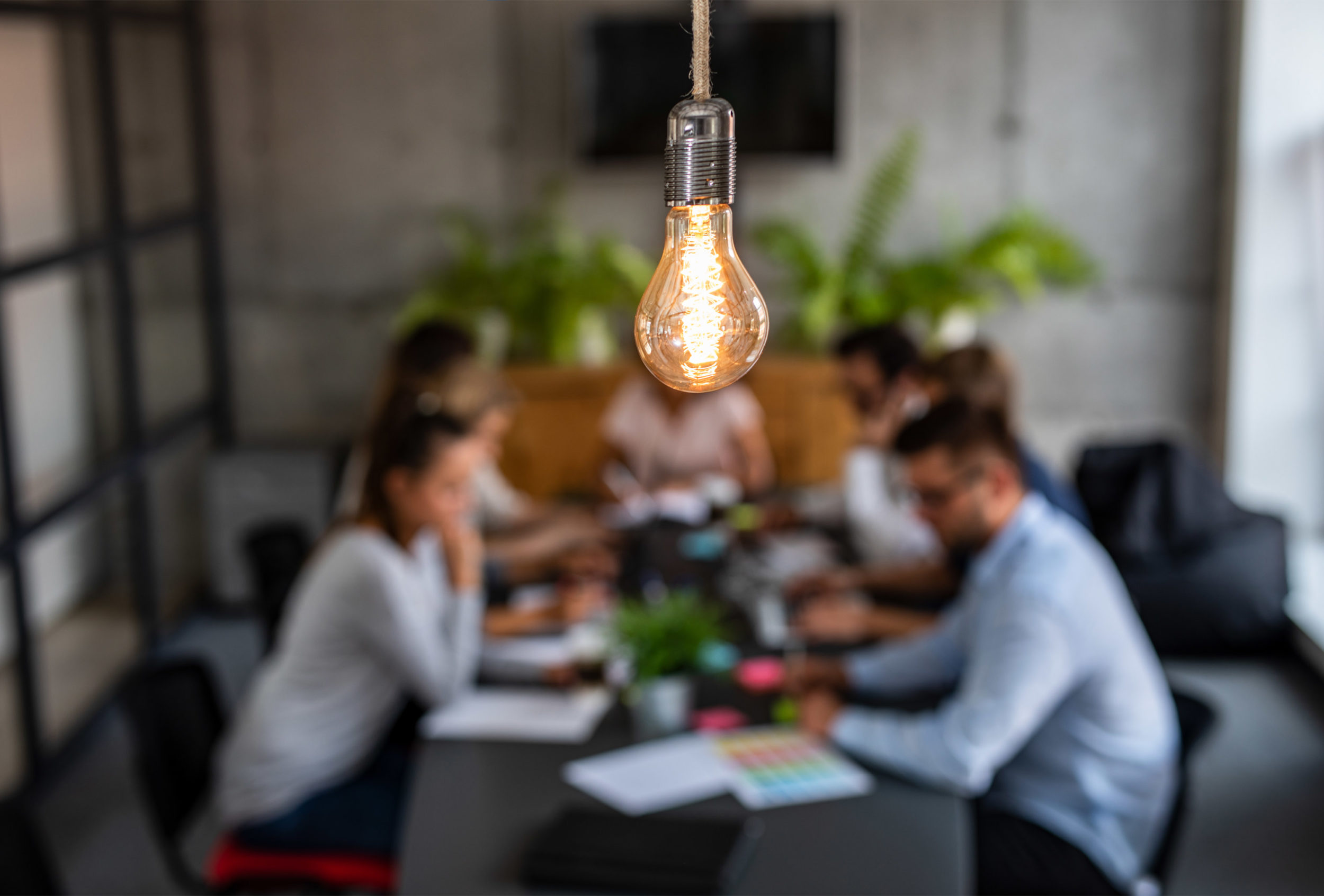 Light bulb above young people