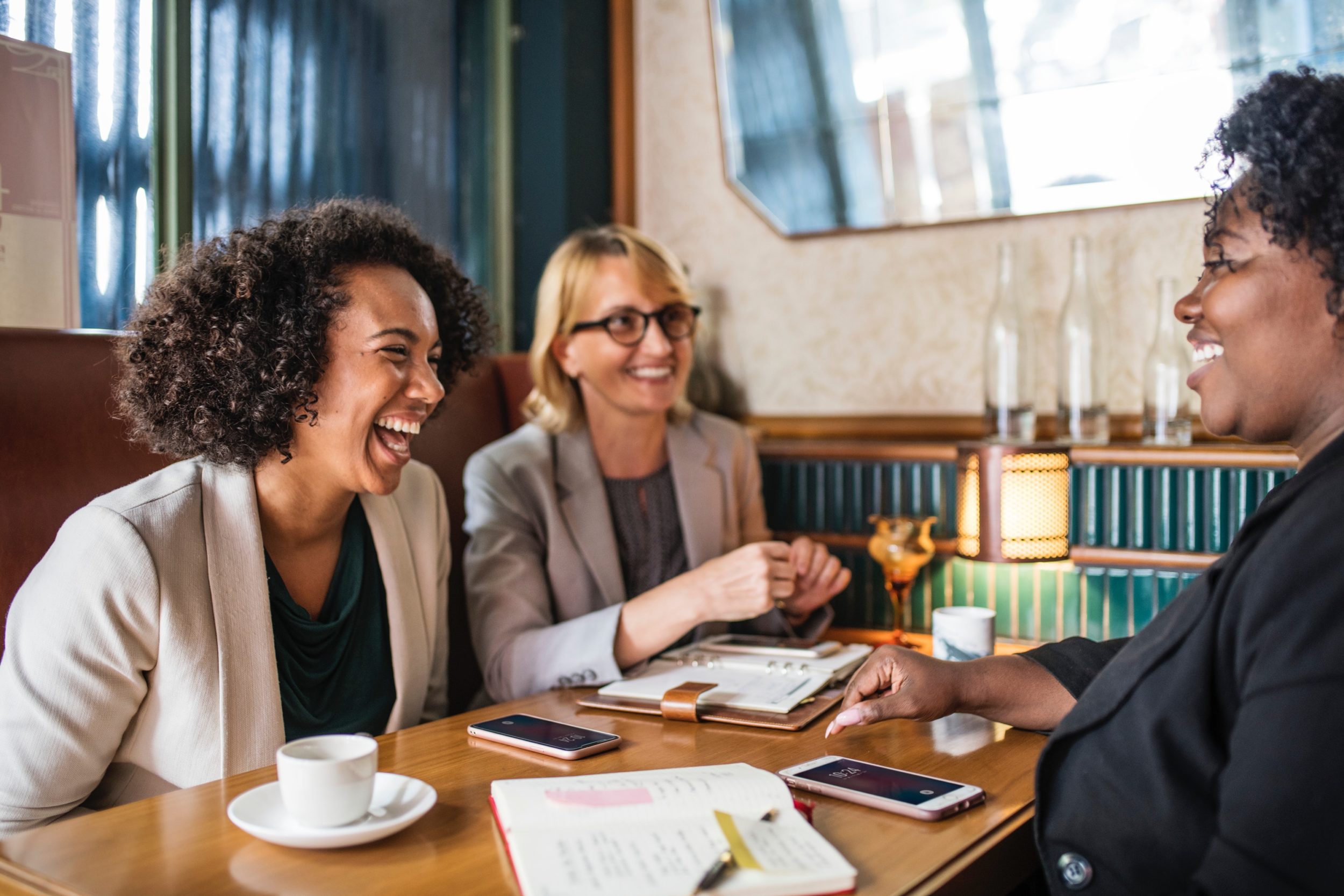 3 women talking and laughing