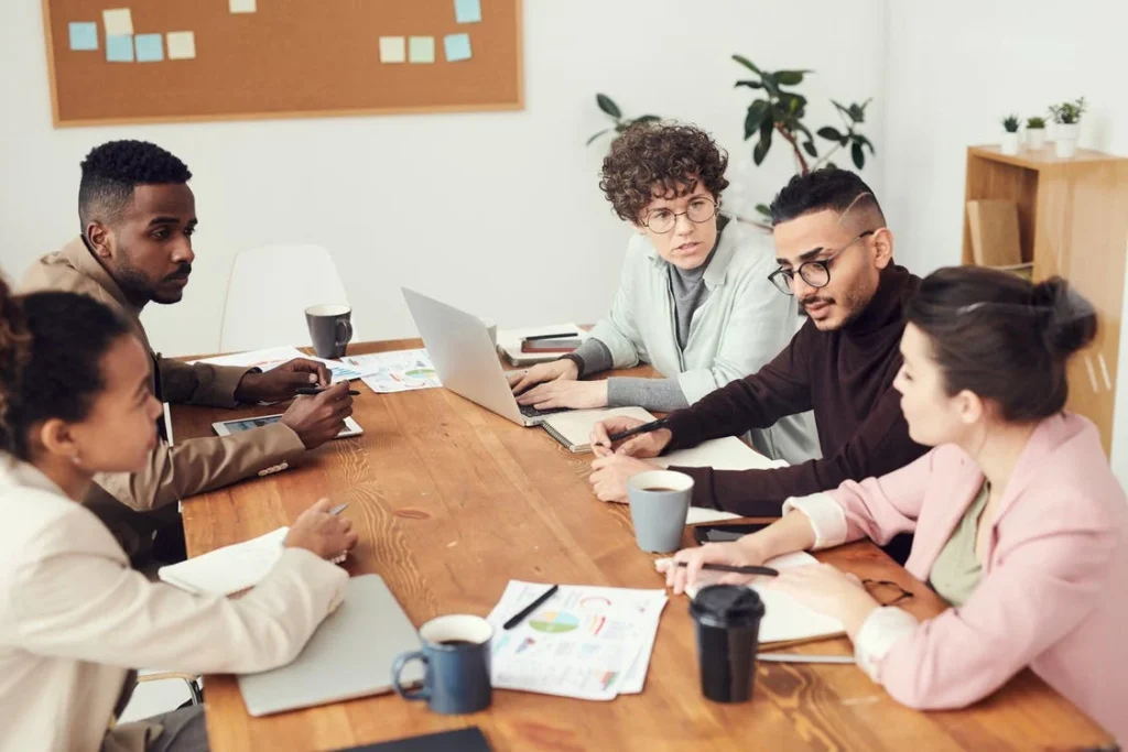 colleagues have a meeting round a table in office